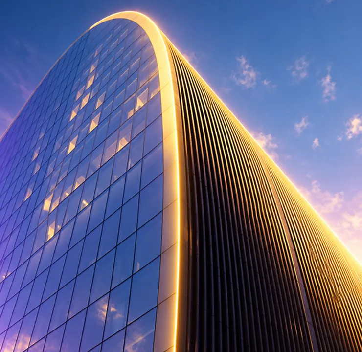 Glass office tower lit gold at dusk